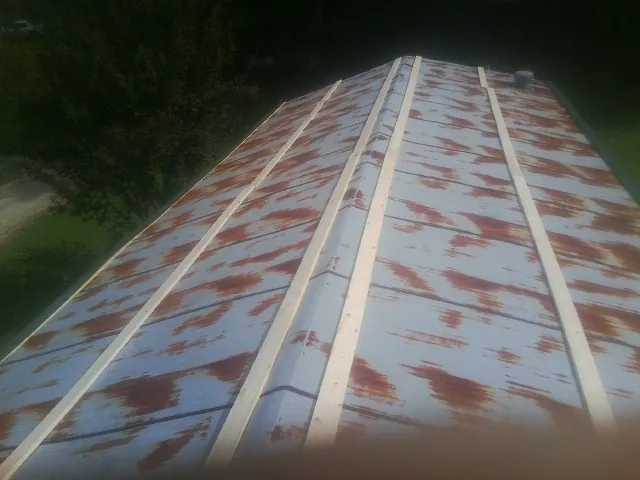 Rusted metal roof panels with new wood purlins before replacement — Storm Damage Roof Repair in Wylie by Roofing Brothers