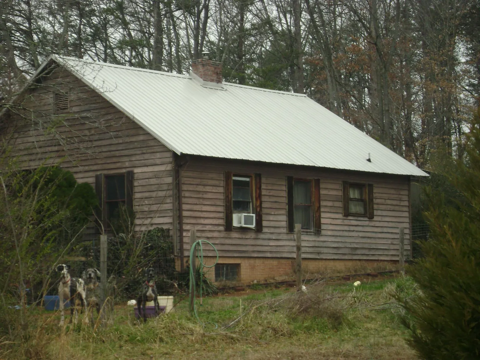 White metal roof on an old wood sided farmhouse, from a Metal Roof Installation job in Wylie